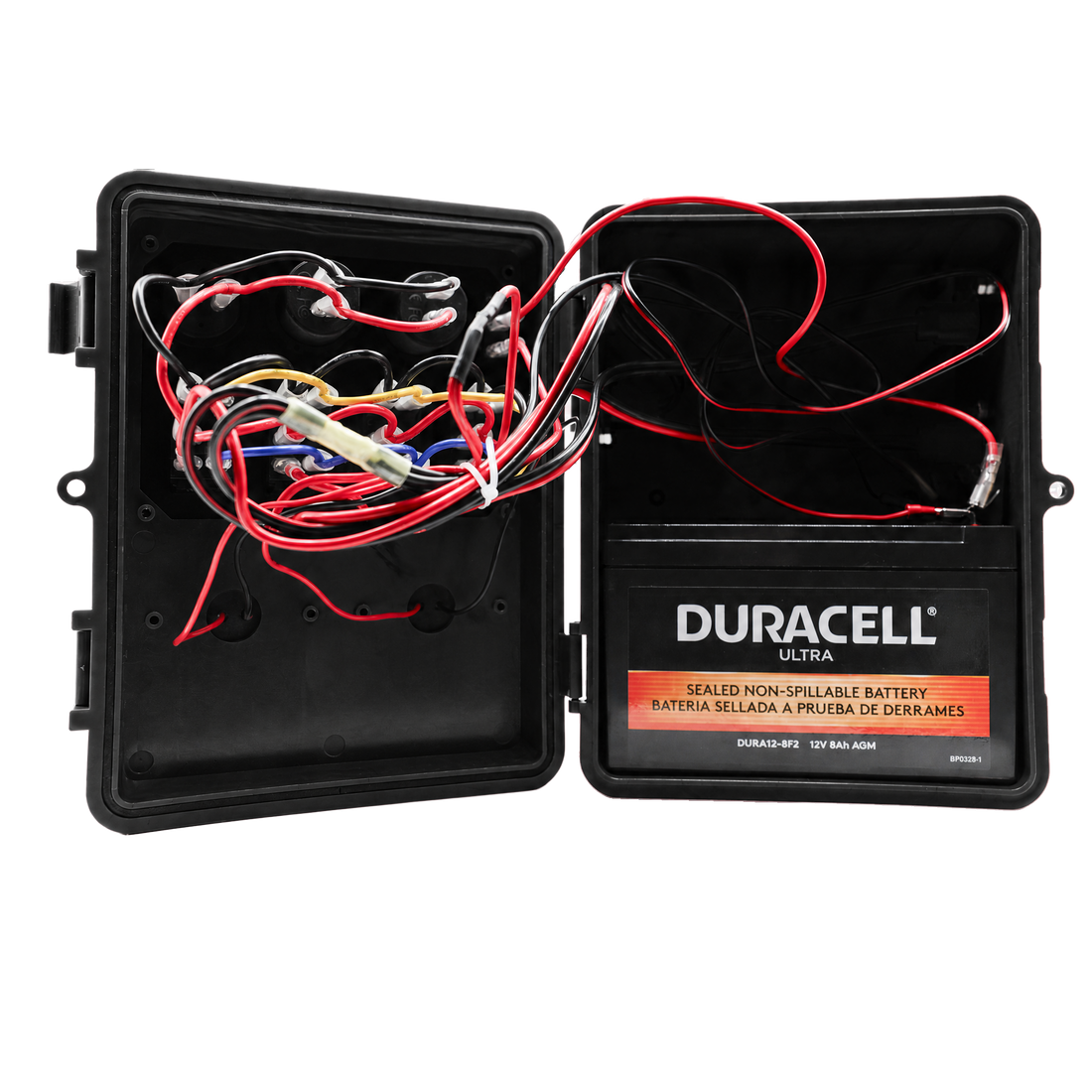 An open black plastic battery terminal cover showing internal wiring and a Duracell Ultra sealed non-spillable battery inside, photographed on a white background.