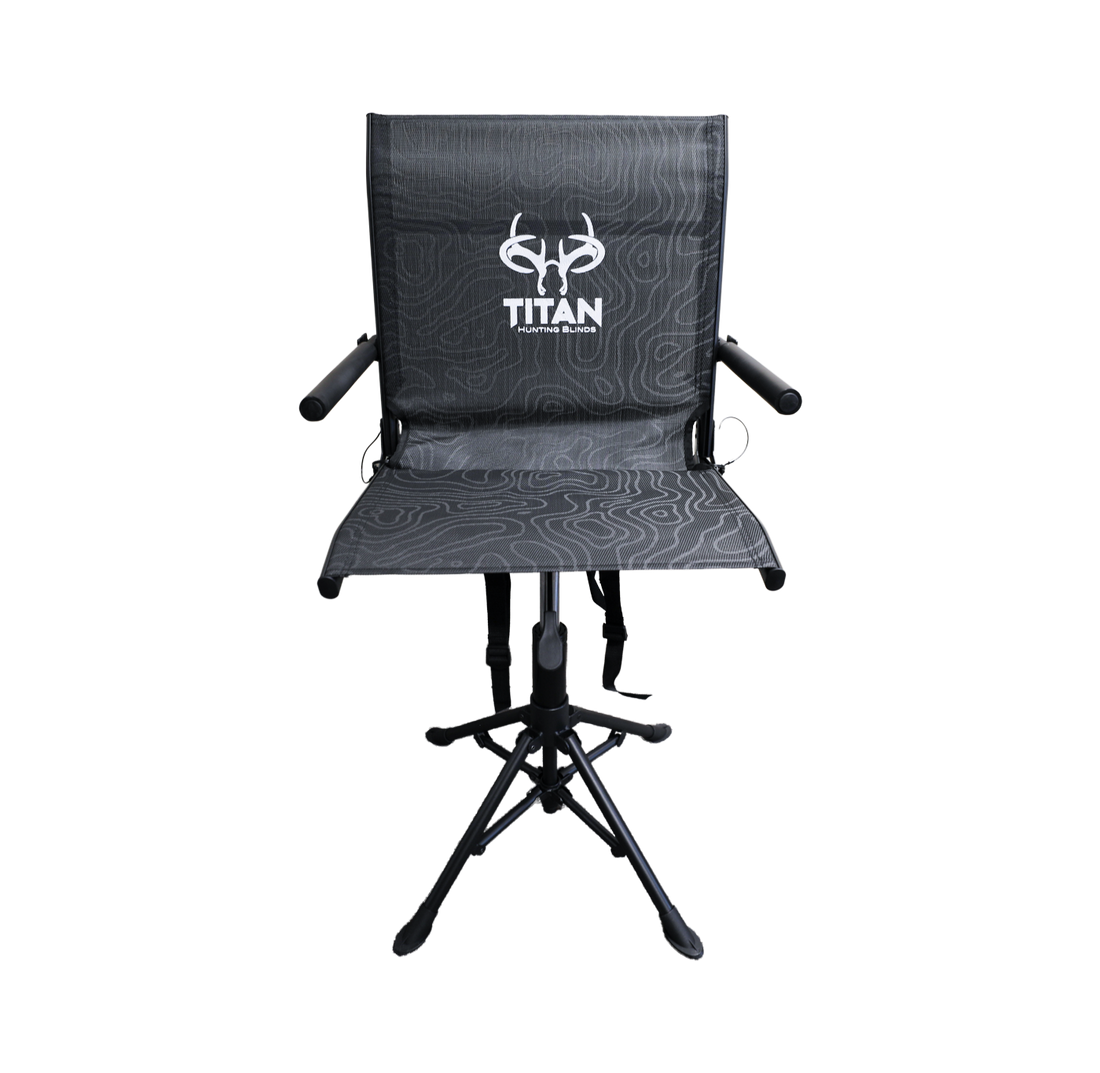 A black folding hunting chair with a textured seat and backrest, featuring a white 'TITAN' brand logo on the backrest, set against a plain white background.