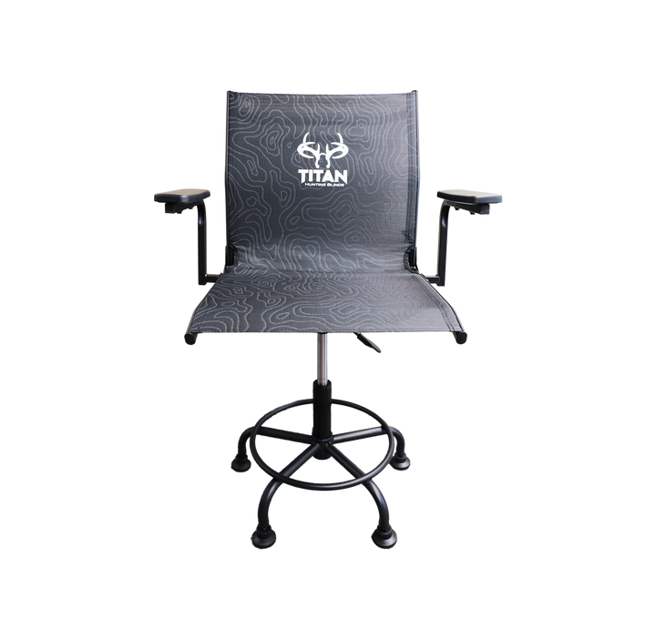 A modern hunting chair with a black and gray topographic pattern fabric, featuring a white 'TITAN' logo on the backrest. It has adjustable black armrests, a black gas-lift swivel base with a footrest ring, and black casters, shown against a plain white background.