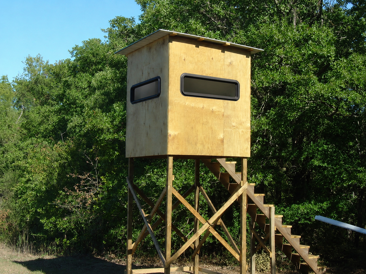 Wooden hunting blind in a forest setting with a representation of Titan Windows installed on it.