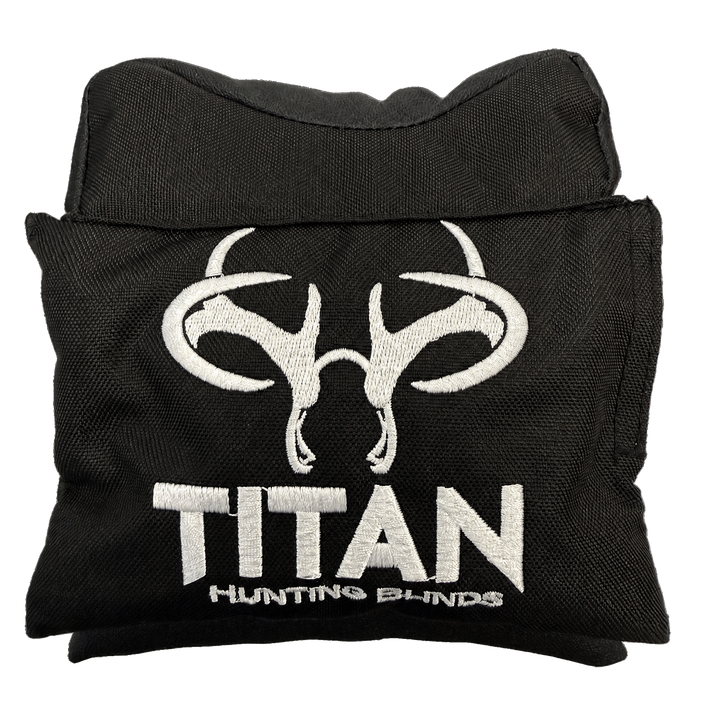 A folded black window shooting rest for a hunting blind with a white embroidered buck skull logo and the text 'TITAN HUNTING BLINDS' on the front, isolated on a white background.