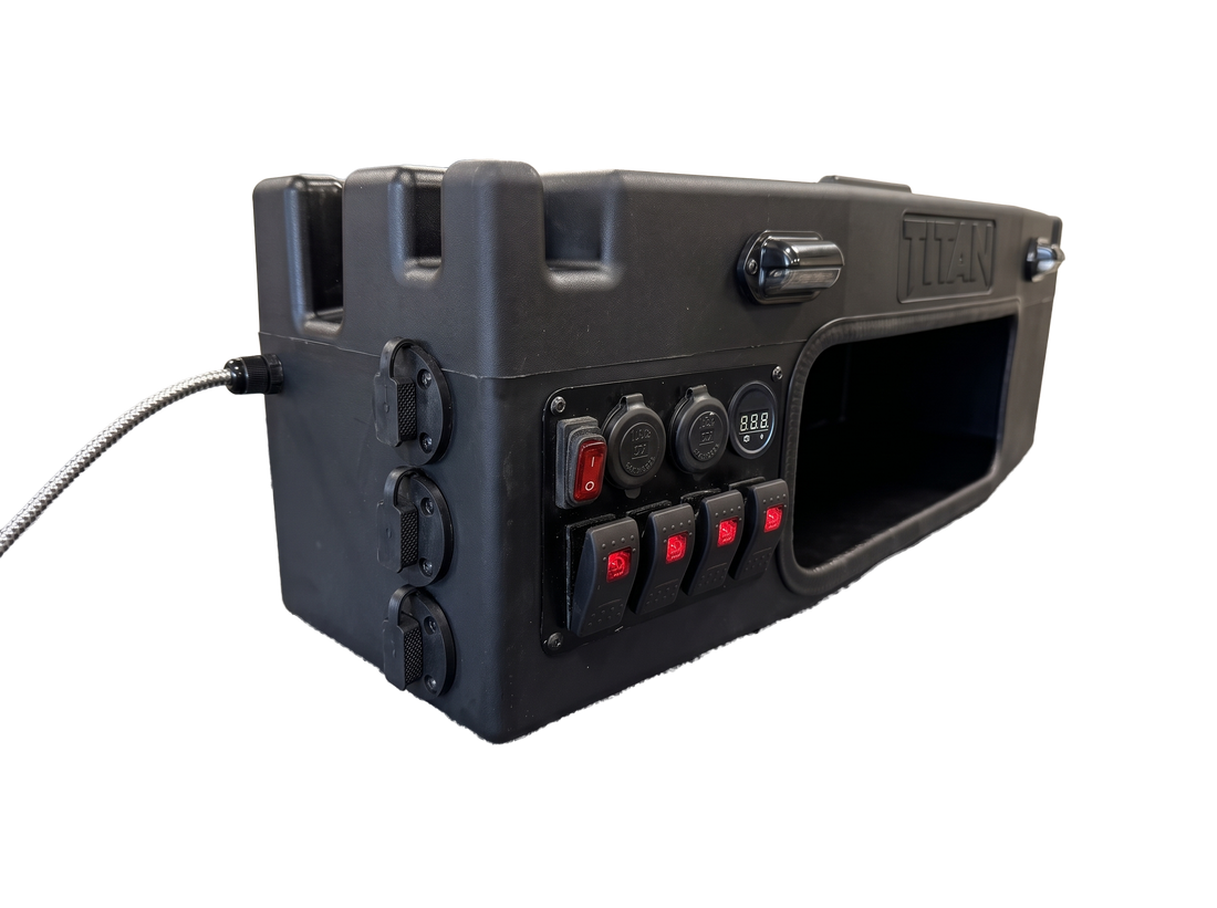 A rugged black tactical hard case with a built-in control panel featuring rocker switches, power outlets, and a large front cutout, shown on a plain white background.