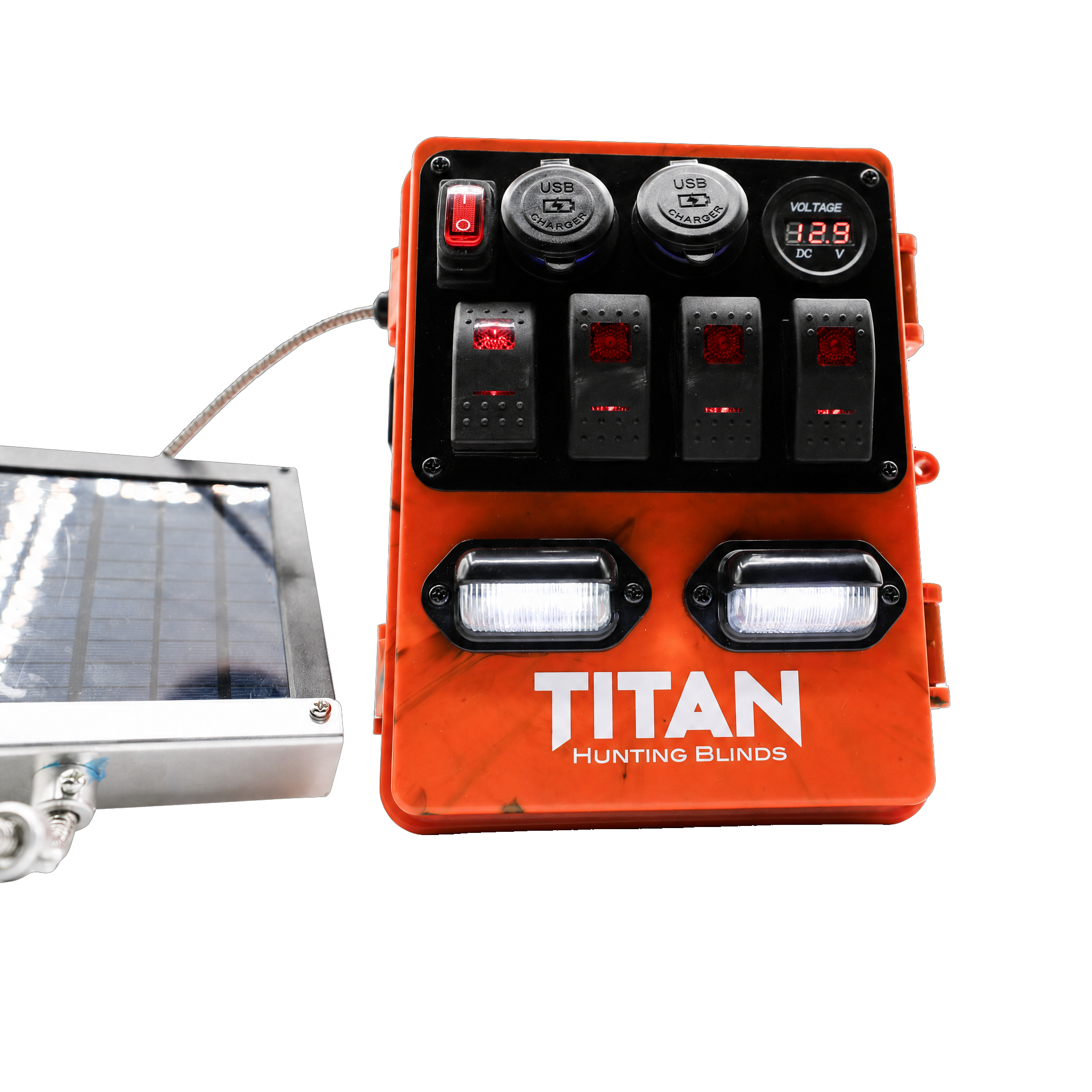 An orange TITAN Hunting Blinds power distribution unit with multiple switches, outlets, and lights, shown next to a small solar panel on a white background.