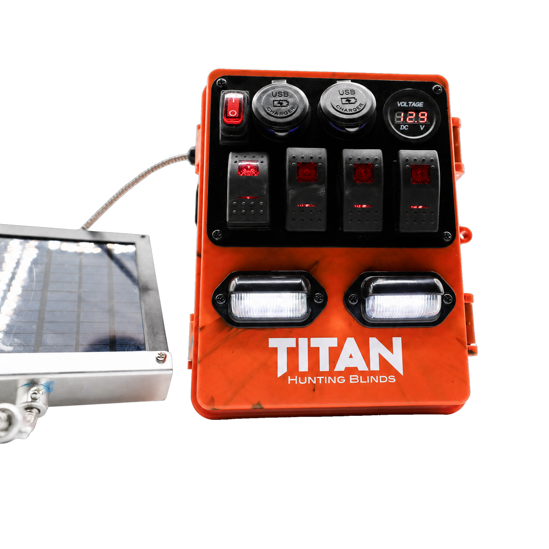 An orange TITAN Hunting Blinds power distribution unit with multiple switches, outlets, and lights, shown next to a small solar panel on a white background.