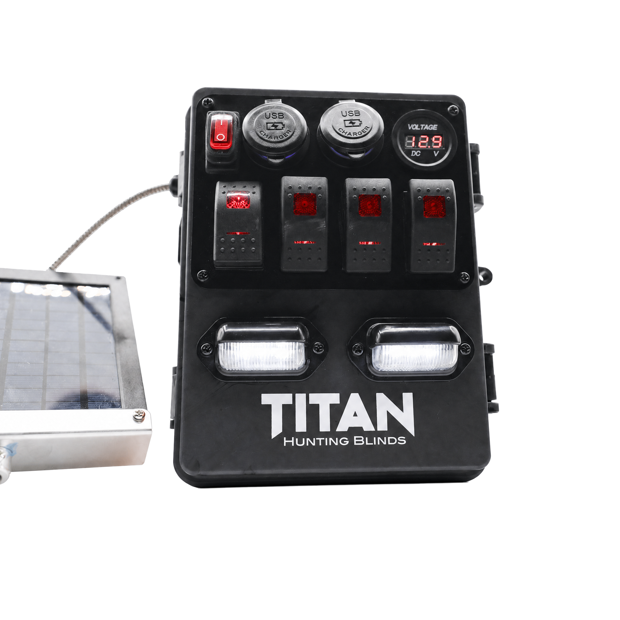Black TITAN Hunting Blinds solar power strip with four switches, two USB ports, a digital voltmeter display, and two LED light bars, shown with a solar panel cable on a white background.