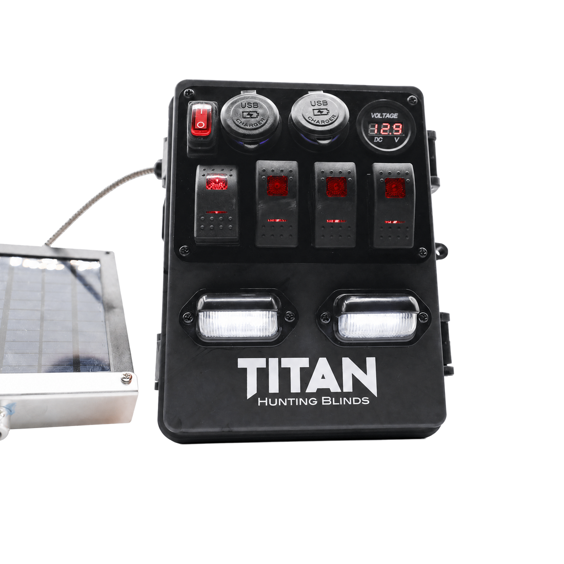 Black TITAN Hunting Blinds solar power strip with four switches, two USB ports, a digital voltmeter display, and two LED light bars, shown with a solar panel cable on a white background.